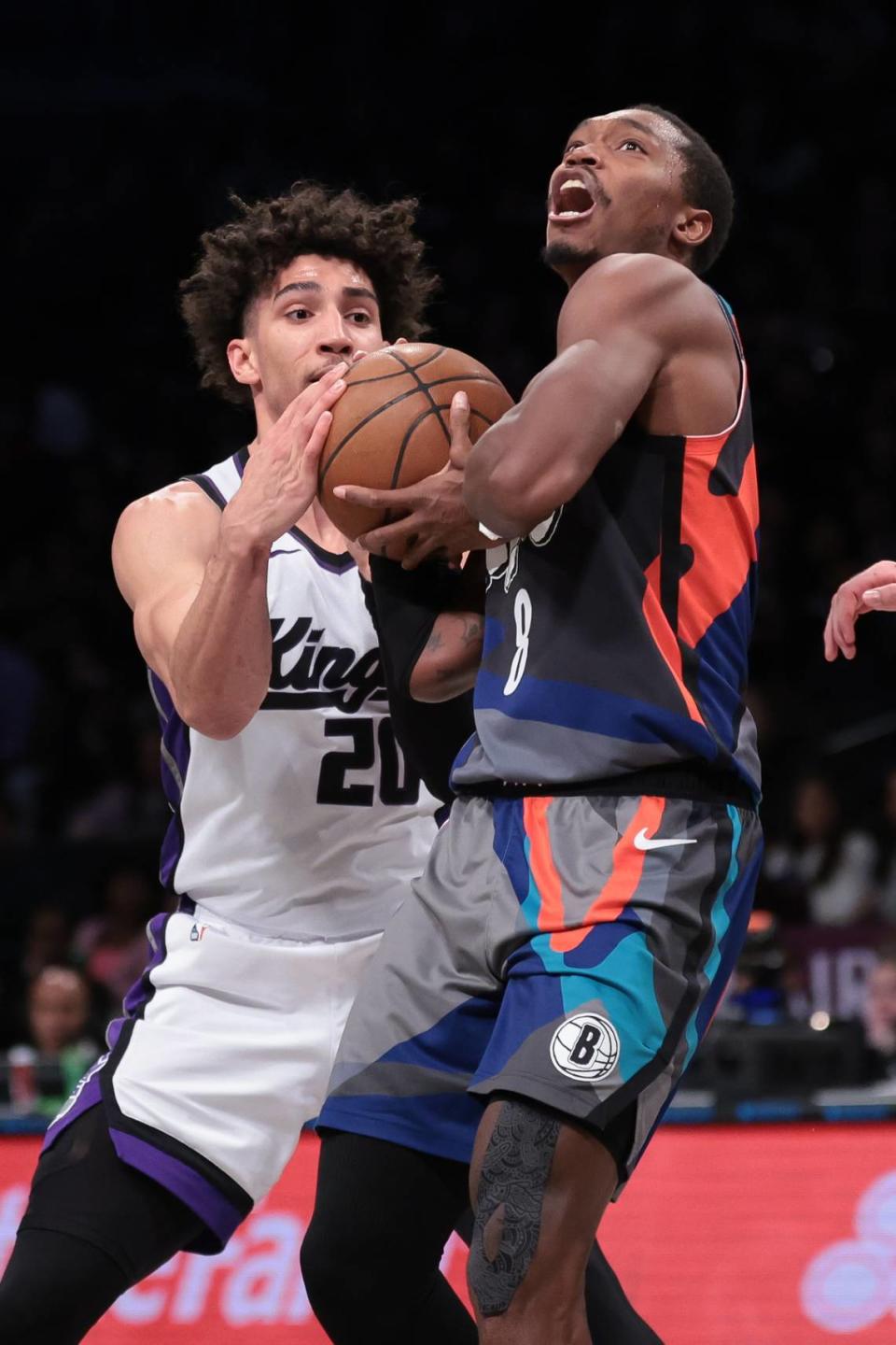 Brooklyn Nets guard Lonnie Walker IV (8) is fouled by Sacramento Kings guard Colby Jones (20) during the second half Sunday, April 7, 2024, at Barclays Center in Brooklyn, New York.