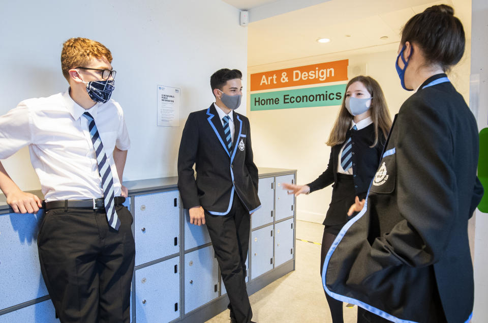 Students at St Columba's High School, Gourock, wear protective face masks as they head to lessons as the requirement for secondary school pupils to wear face coverings when moving around school comes into effect from today across Scotland.