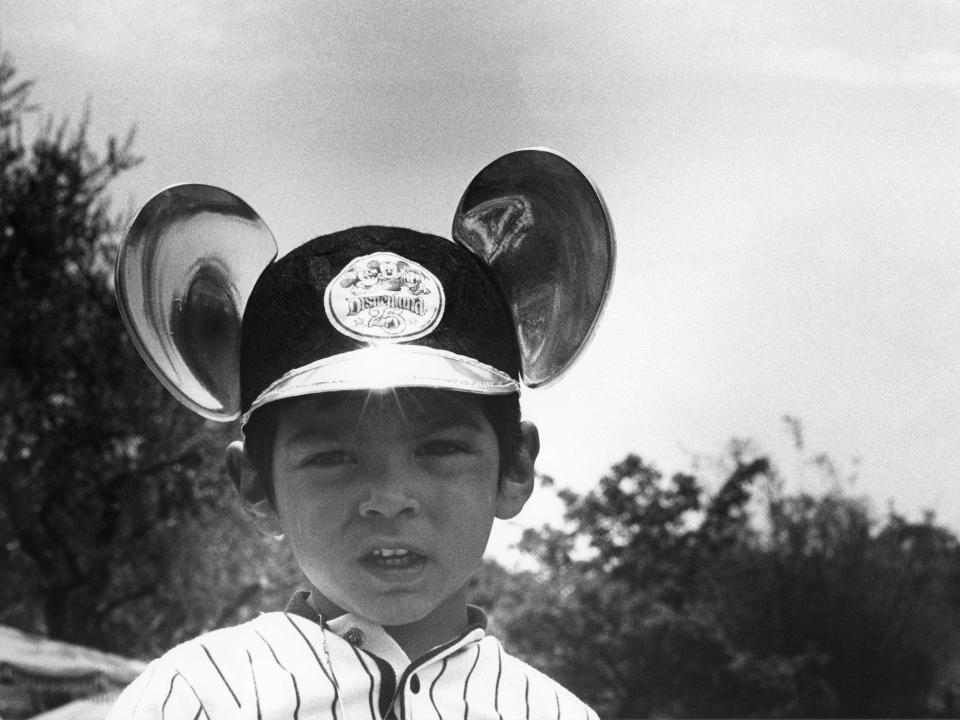 A young boy wears a hat with Mickey ears at Disneyland in 1980.