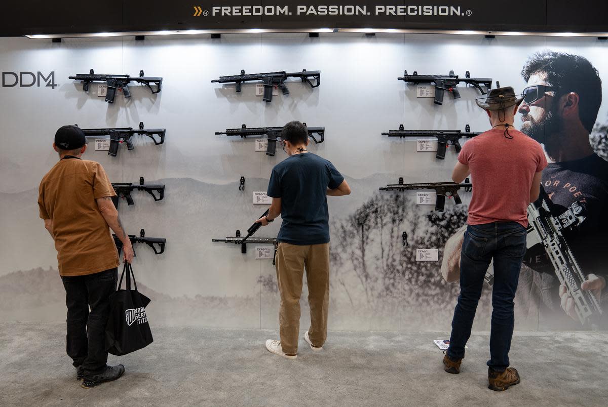 Attendees browse at the Daniel Defense firearms booth at the NRA Annual Meetings and Exhibits at the Kay Bailey Hutchison Convention Center in Dallas on May 17, 2024.