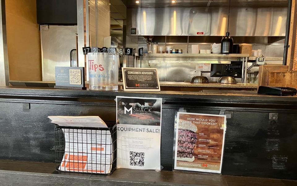 A sign near the menus on the front counter of M Shack, 10281 Midtown Parkway in St. Johns Town Center, advertises the upcoming sale of all the restaurant's kitchen equipment and furnishings following its closing on Sunday, March 17, 2024.
