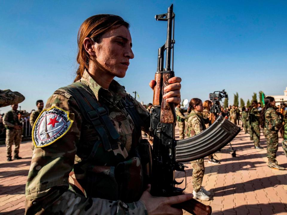 Kurdish fighters attend a funeral for political leader Hevrin Khalaf, who was reportedly executed by pro-Turkish militants in northeastern Syria: AFP via Getty Images