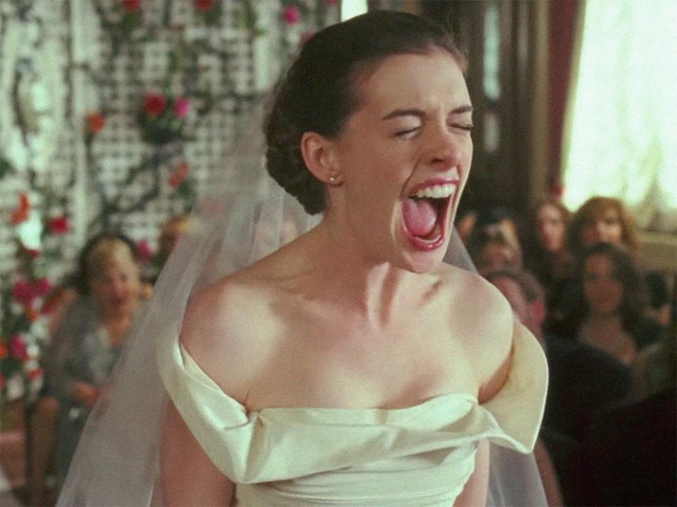 A woman screaming in her wedding dress.