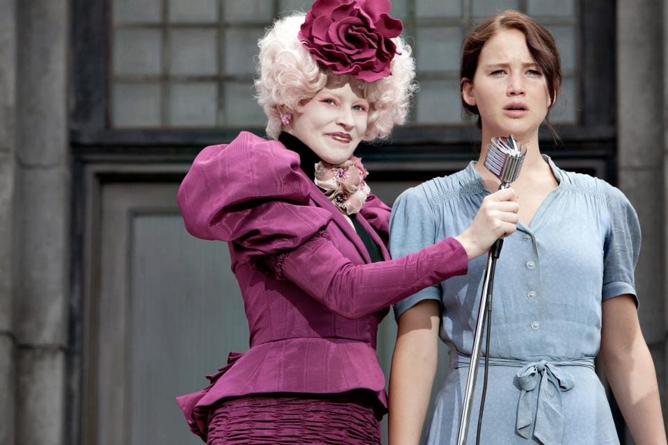 Effie Trinket (Elizabeth Banks) and Katniss Everdeen (Jennifer Lawrence) during "The Hunger Games" reaping.