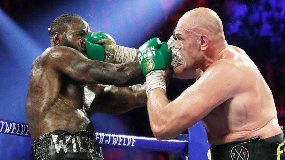 Pictured here, Tyson Fury lands a brutal punch on Deontay Wilder's face.