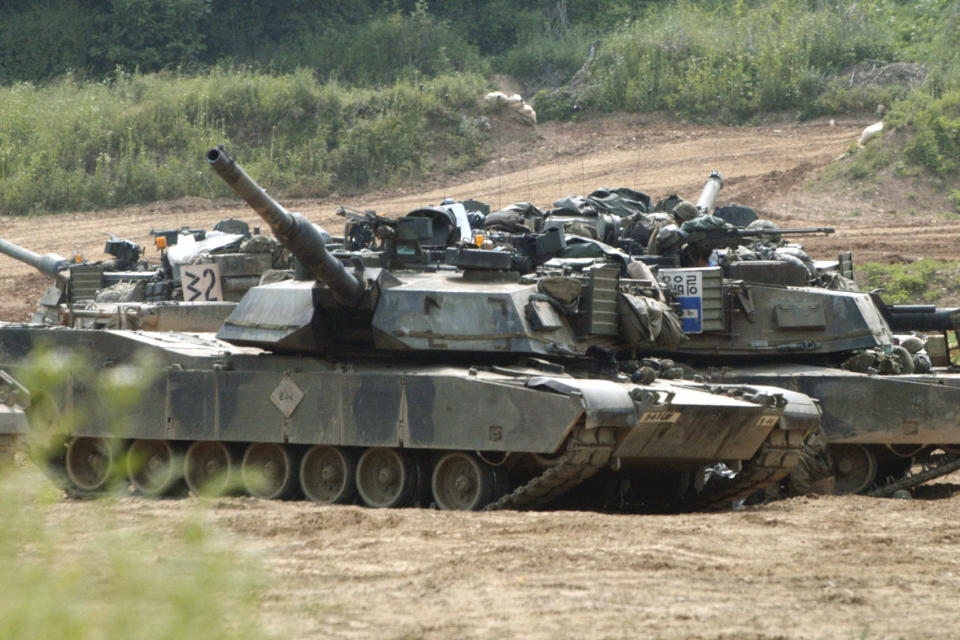 US tanks M1-A1 Abrams block a path at a training range in Paju, near Demilitarized Zone (DMZ), 50 kilometer north of Seoul, on June 9, 2003. China on Thursday, April 11, 2024 announced sanctions against two U.S. defense companies, one of which produces the M1 tank, over what it says is their support for arms sales to Taiwan, the self-governing island democracy Beijing claims as its own territory to be recovered by force if necessary. (AP Photo/Katsumi Kasahara, File)