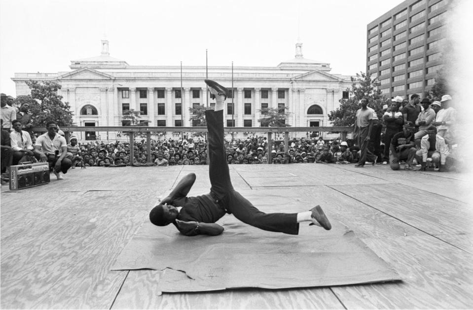 A breakdancer spins on cardboard in front of a massive crowd in Wilmington in July 1984.