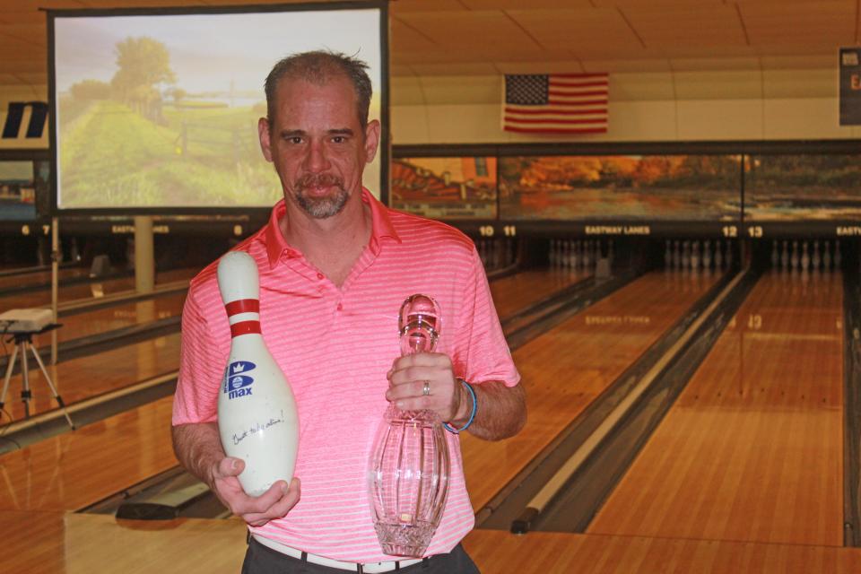 Erie Times-News Open champion Mike Machuga holds the Pat Malone Tuesday Troopers pin and the championship trophy pin at Eastway Lanes on Jan. 30, 2022.