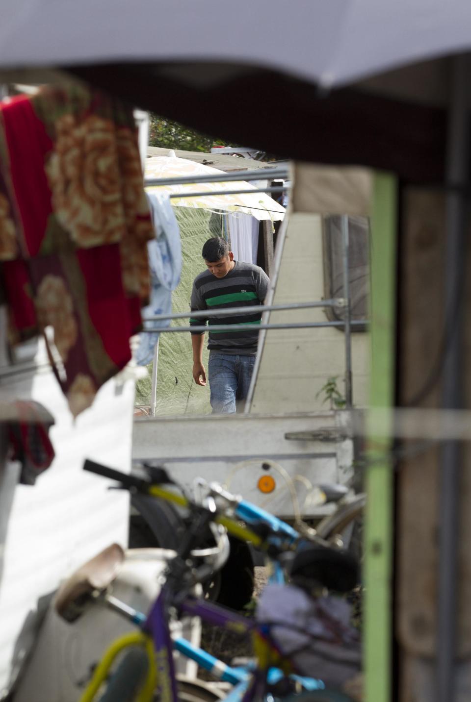 A man walks through a Gypsy camp in Wissous, outside Paris, Wednesday Aug .22, 2012.French Prime Minister Jean-Marie Ayrault was to host a meeting of ministers on the issue of Roma, or Gypsies, in France after the government launched its latest campaign this month to drive them from their camps..(AP/Jacques Brinon)