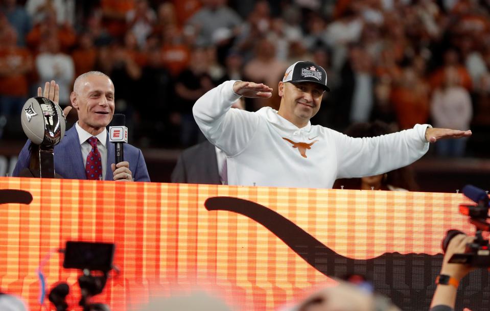 Texas head football coach Steve Sarkisian tries to quiet fans as they boo the Big 12 Commissioner Brett Yormark following the game between the Oklahoma State Cowboys and the Longhorns at the AT&T Stadium in Arlington.