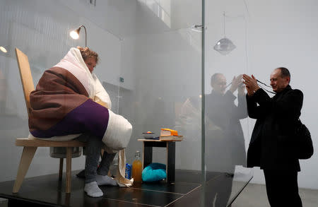 French artist Abraham Poincheval is seen in a vivarium on the first day of his performance in an attempt to incubate chicken eggs, which takes from 21 to 26 days, at the Palais de Tokyo Museum in Paris, France. REUTERS/Gonzalo Fuentes