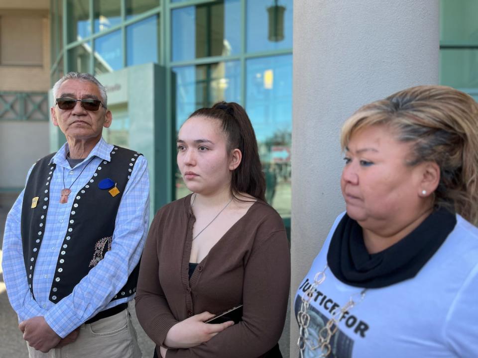 Lily Speed-Namox, centre, stands outside the Prince George courthouse after hearing that manslaughter charges in the death of her father, Dale Culver, are no longer being pursued. She is joined by Wet'suwet'en hereditary Chief Namoks (John Ridsdale) and Culver's cousin, Debbie Pierre. (Andrew Kurjata/CBC - image credit)