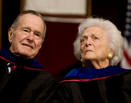 FILE PHOTO - Former President George H.W. Bush (L), and former first lady Barbara Bush attend the Texas A&M University commencement ceremony in College Station, Texas, December 12, 2008. REUTERS/Larry Downing/File Photo