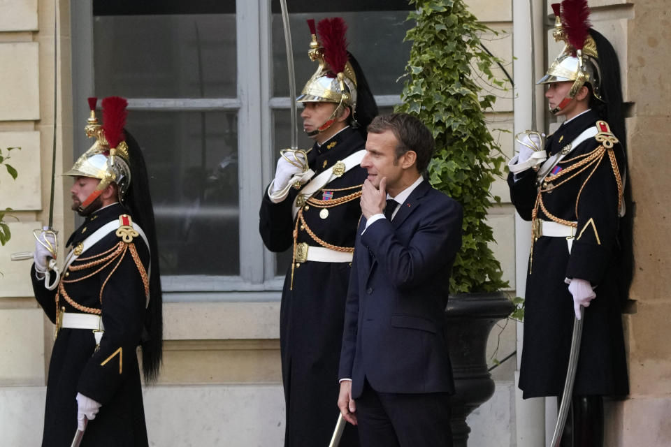 France's President Emmanuel Macron waits for world leaders before a conference in Paris, Friday, Nov. 12, 2021. France is hosting an international conference on Libya on Friday as the North African country is heading into long-awaited elections next month. (AP Photo/Francois Mori)