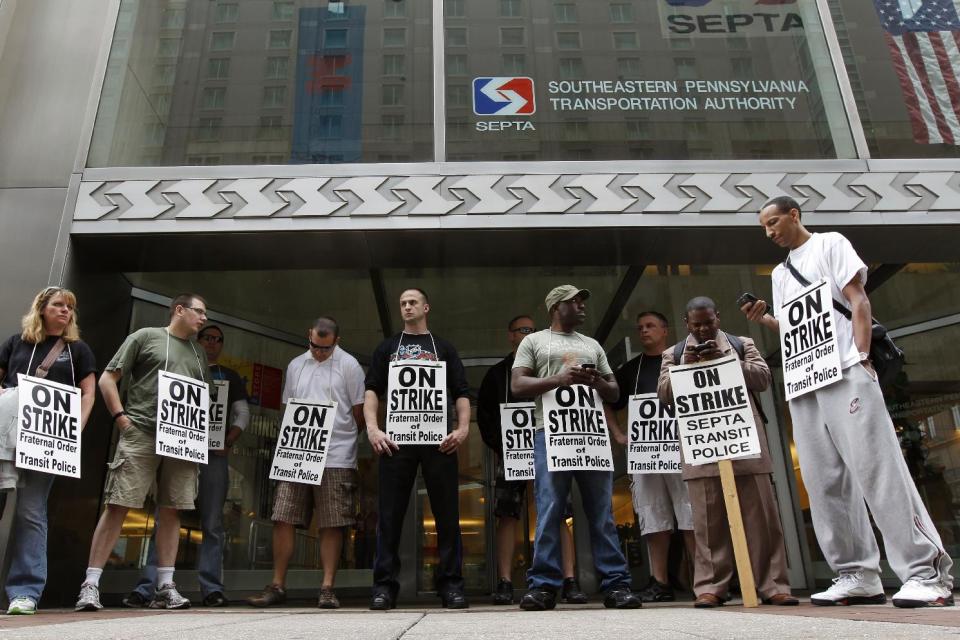 Striking Southeastern Pennsylvania Transportation Authority police officers picket outside the transit agency's offices Wednesday, March 21, 2012, in Philadelphia. (AP Photo/Matt Rourke)