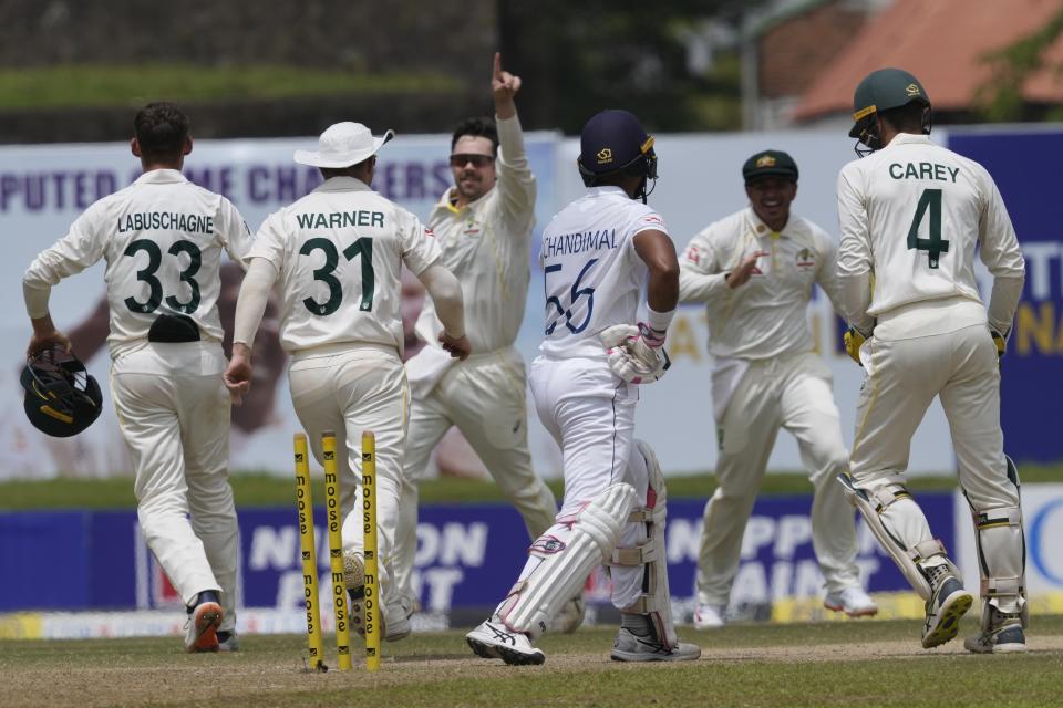 Australia's Travis Head, centre, celebrates taking the wicket of Sri Lanka's Dinesh Chandimal with his teammates during the day three of the first test cricket match between Australia and Sri Lanka in Galle, Sri Lanka, Friday, July 1, 2022. (AP Photo/Eranga Jayawardena)