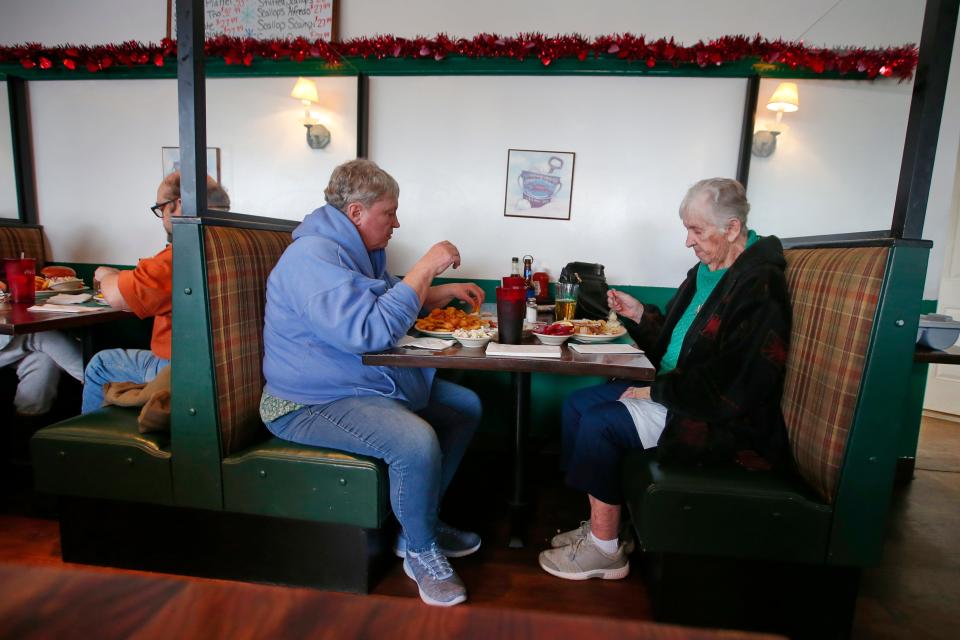 Long time customers, Barbara Vigilant and Kathy Cruz, enjoy lunch at Cape Quality Seafood on Dartmouth Street in Dartmouth.