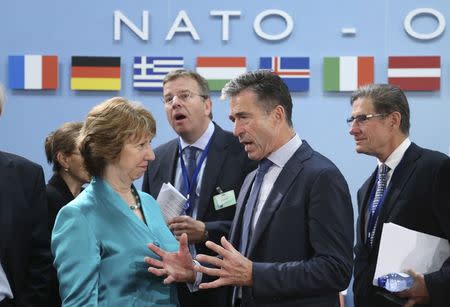 European Union foreign policy chief Catherine Ashton listens to NATO Secretary General Anders Fogh Rasmussen (R) during a NATO foreign ministers meeting at the Alliance headquarters in Brussels June 25, 2014. REUTERS/Francois Lenoir