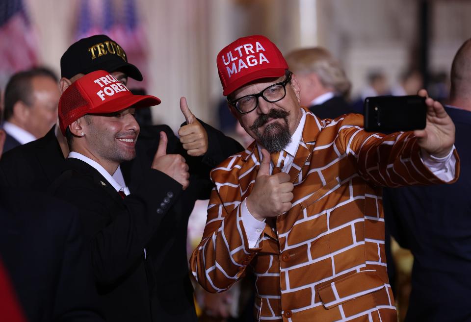 MAGA supporters pose for photographs ahead of Trump announcement at Mar-a-Lago on Tuesday