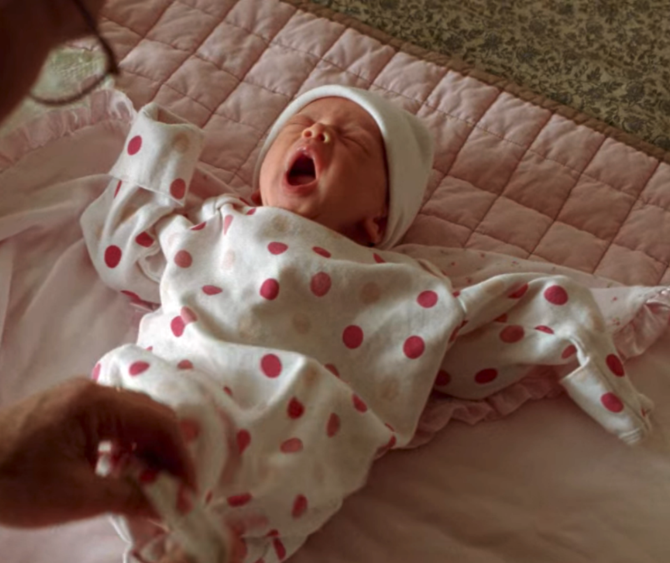 Walt and Skyler's absurdly adorable baby yawns widely in an oversize onesie