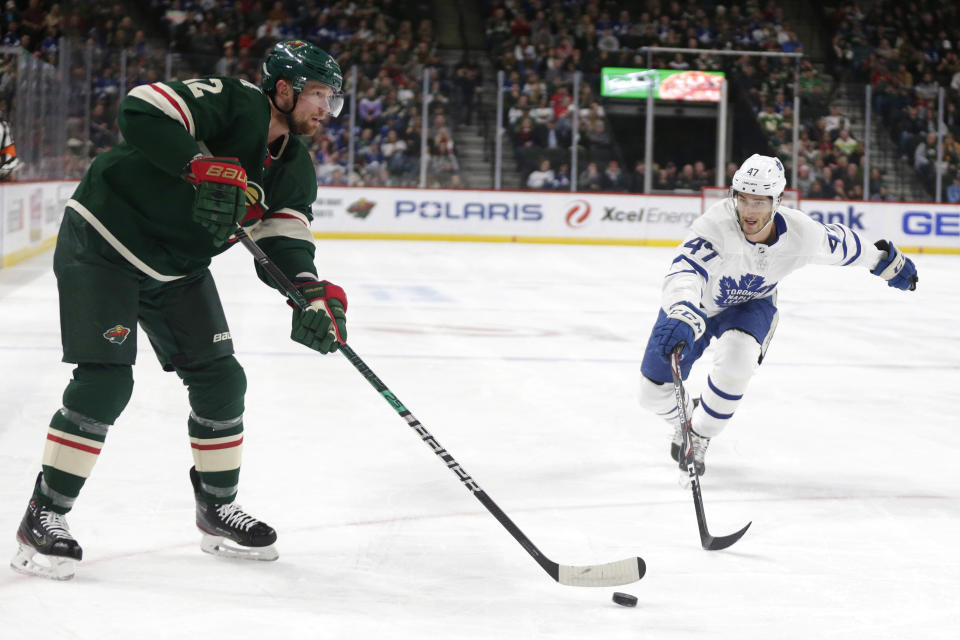 Minnesota Wild center Eric Staal (12) controls the puck in front of Toronto Maple Leafs left wing Pierre Engvall (47) and Maple Leafs center Auston Matthews (34) in the first period of an NHL hockey game Tuesday, Dec. 31, 2019, in St. Paul, Minn. (AP Photo/Andy Clayton-King)