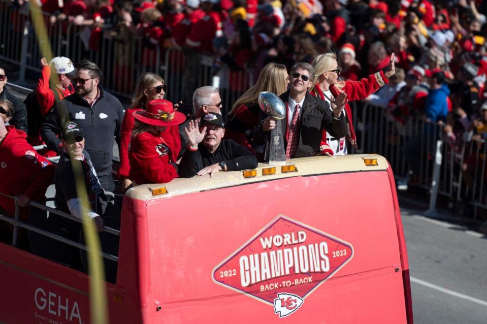 Kansas City Chiefs Head Coach Andy Reid waves as Chiefs CEO Clark Hunt holds the Lombardi Trophy.<span class="copyright">Amy Kontras—AFP/Getty Images</span>