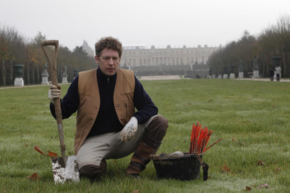 Molecatcher Jerome Dormion poses for a photo in the park of the Chateau de Versailles, seen in background, west of Paris, Thursday, Nov. 22, 2012. The king is dead, but the molecatcher lives on. He even signs SMS messages: “Molecatcher to the king.” It’s been over two centuries since Louis XVI was guillotined on Paris’ Place de la Concorde, but the job of hunting the underground rodent that so troubled French monarchs on the grounds of the Versailles palace still exists. (AP Photo/Thibault Camus)