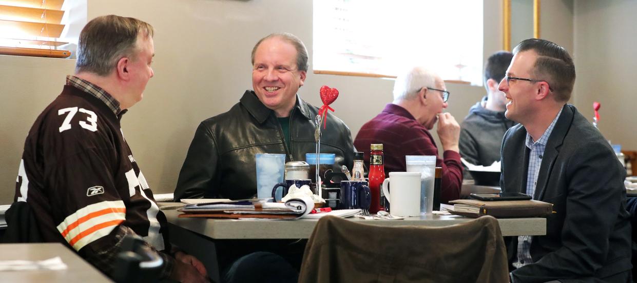 The Beacon Journal’s Joe Thomas, left, and Mark Price, center, sit down for lunch with Full Spectrum Marketing’s Josh Gordon on Tuesday at Akron Family Restaurant to talk about what it’s like sharing the same names as Cleveland sports stars.