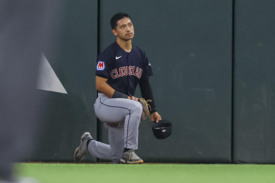 Cleveland Guardians' Steven Kwan reacts after failing to rob a home run from Texas Rangers' Marcus Semien during the first inning of a baseball game against the Texas Rangers, Sunday, July 16, 2023, in Arlington, Texas. (AP Photo/Gareth Patterson)
