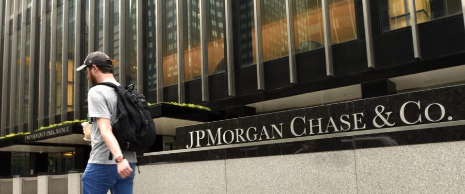 Man walks in front of a JPMorgan bank