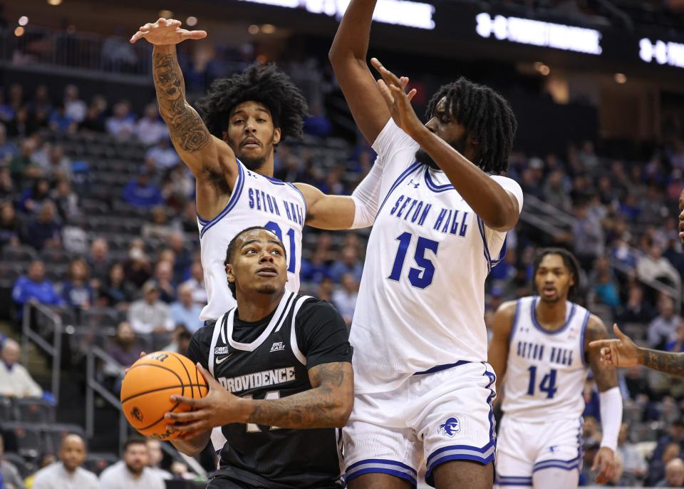 Jan 24, 2024; Newark, New Jersey, USA; Providence Friars guard Corey Floyd Jr. (14) drives to the basket as Seton Hall Pirates guard David Gabriel (41) and center Jaden Bediako (15) defend during the first half at Prudential Center. Mandatory Credit: Vincent Carchietta-USA TODAY Sports