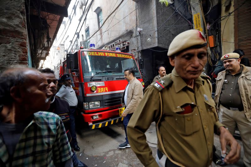 A fire engine is seen at the site of a fire that swept through a factory where labourers were sleeping on Sunday, in New Delhi