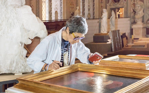 A curator examines Caravaggio’s portrait of Pope Urban VIII, which is in the private collection of the Galleria Borghese  - Credit: Massimo Siragusa