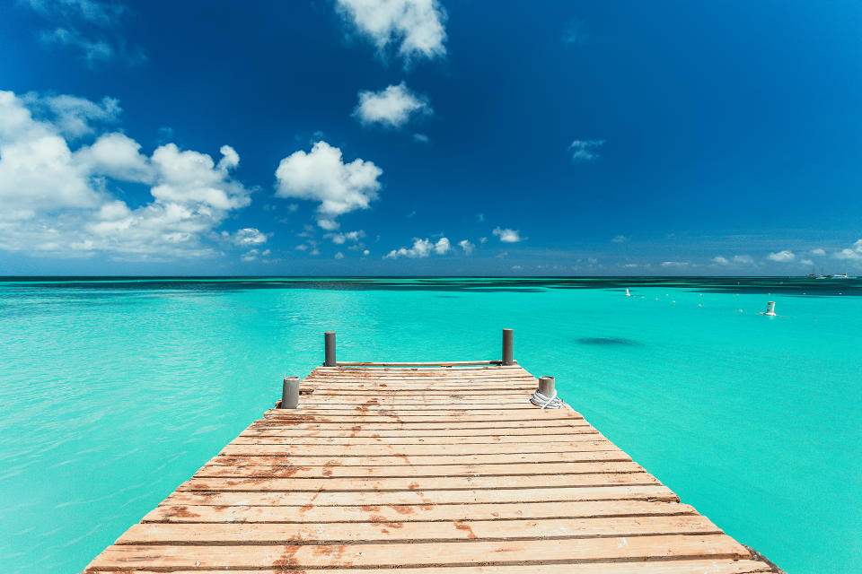 Pier Over the clear blue sea Against Blue Sky (Jeroen Lucas / EyeEm / Getty Images/EyeEm)