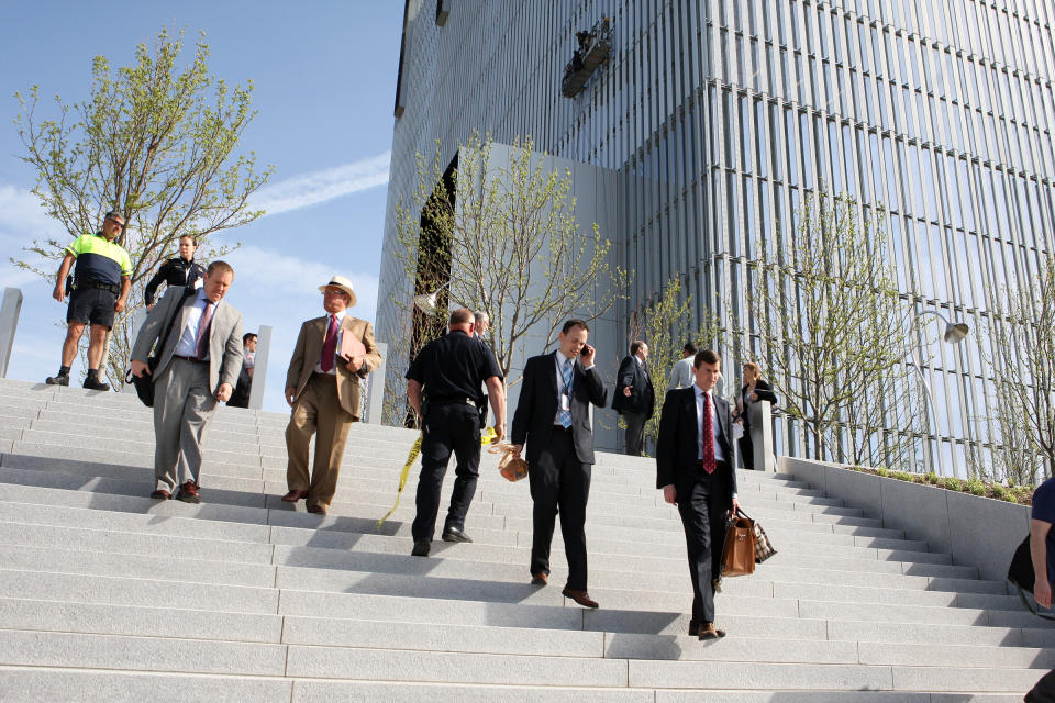 Federal Courthouse employees evacuate as police investigate a shooting inside the Federal Courthouse, Monday, April 21, 2014, in Salt Lake City. The shooting has left at least one person injured, a spokeswoman for the U.S. attorney said. (AP Photo/The Deseret News, Hugh Carey) SALT LAKE TRIBUNE OUT; MAGS OUT