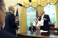 President Donald Trump holds a letter presented to him by Chinese Vice Premier Liu He in the Oval Office of the White House in Washington, Friday, Oct. 11, 2019. (AP Photo/Andrew Harnik)