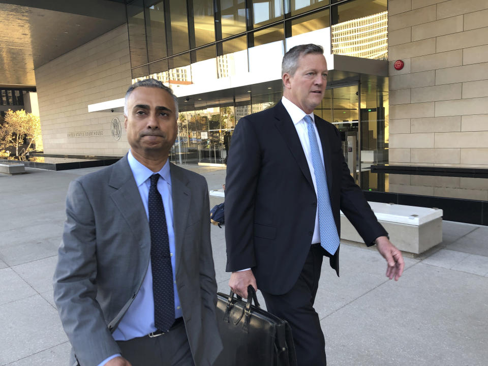 Imaad Zuberi, left, leaves the federal courthouse with his attorney Thomas O'Brien, right, in Los Angeles, on Friday, Nov. 22, 2019. Zuberi pleaded guilty to funneling donations from foreigners to U.S. political campaigns. (AP Photo/Brian Melley)