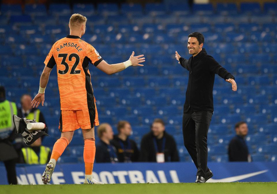 Mikel Arteta celebrates victory with Aaron Ramsdale after the win at Chelsea.