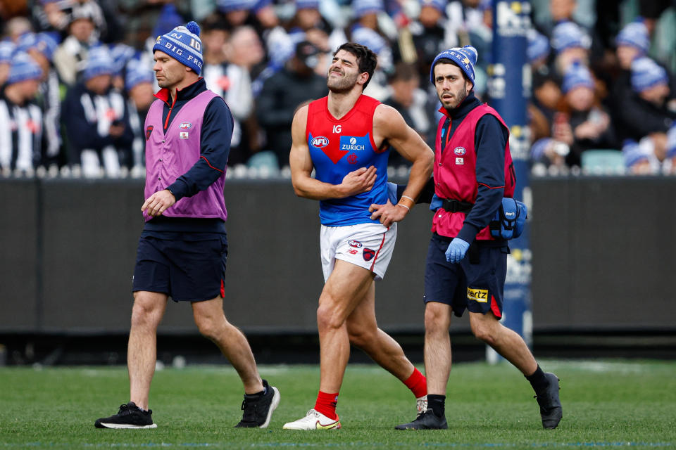 MELBOURNE, AUSTRALIA - JUNE 10: Christian Petracca of the Demons leaves the field injured during the 2024 AFL Round 13 match between the Collingwood Magpies and the Melbourne Demons at The Melbourne Cricket Ground on June 10, 2024 in Melbourne, Australia. (Photo by Dylan Burns/AFL Photos via Getty Images)