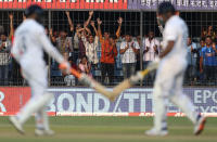 Spectators cheer after a boundary hit by India's Umesh Yadav, foreground right, during the second day of first cricket test match between India and Bangladesh in Indore, India, Friday, Nov. 15, 2019. (AP Photo/Aijaz Rahi)