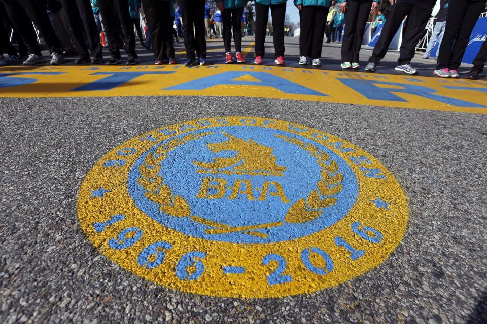 FILE - An seal honoring 50 years of women running in the Boston Marathon covers the street in front of the start line of the 120th Boston Marathon on Monday, April 18, 2016, in Hopkinton, Mass. Once a year for the last 100 years, Hopkinton becomes the center of the running world, thanks to a quirk of geography and history that made it the starting line for the world's oldest and most prestigious annual marathon. (AP Photo/Michael Dwyer, File)