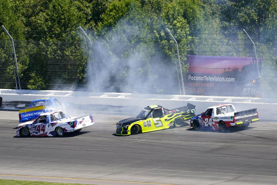 Kris Wright (44), Tyler Hill (5) and Jack Wood (24) maneuver to avoid the sliding Todd Bodine, left, during the NASCAR Truck Series Race at Pocono Raceway, Saturday, July 23, 2022 in Long Pond, Pa. (AP Photo/Matt Slocum)