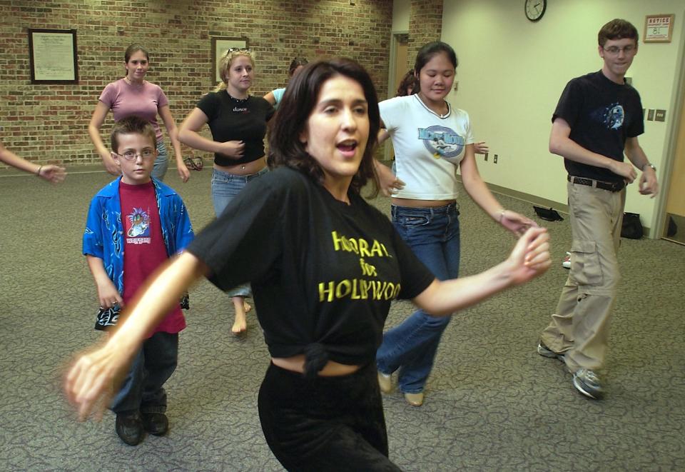 Dance instructor Shannon Calderon works with students in a salsa class at the Edmond Library June 26, 2003. A beloved dancer and teacher, Shannon Calderón Primeau died of cancer in 2015 at the age of 45.