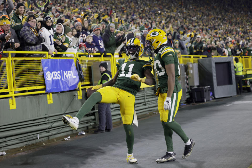 Green Bay Packers wide receiver Jayden Reed (11) celebrates with teammate Bo Melton after catching a 59-yard pass during the second half of an NFL football game against the Chicago Bears Sunday, Jan. 7, 2024, in Green Bay, Wis. (AP Photo/Matt Ludtke)