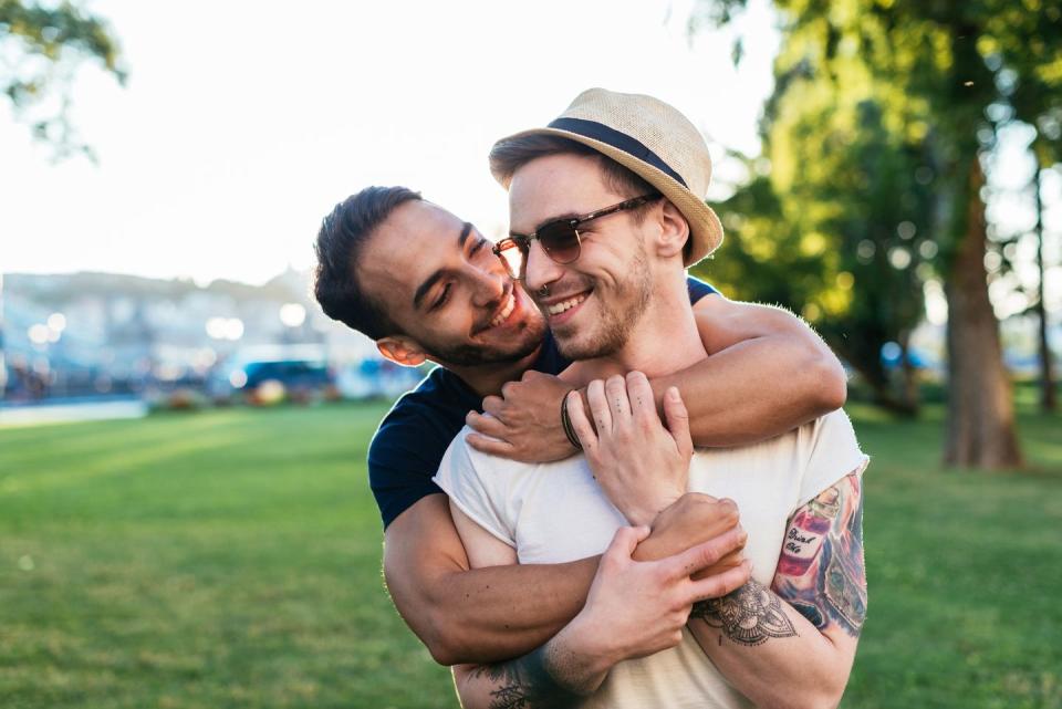 cheerful gay couple expressing love to each other while on vacation