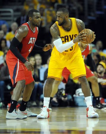 Cleveland Cavaliers forward LeBron James (23) handles the ball against Atlanta Hawks forward Paul Millsap (4) during the fourth quarter in game four of the Eastern Conference Finals of the NBA Playoffs at Quicken Loans Arena. Mandatory Credit: Ken Blaze-USA TODAY Sports