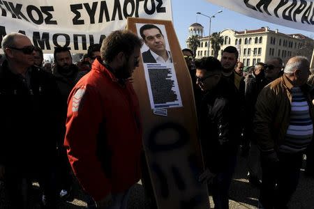 Farmers carry a mock coffin with a picture of Greek Prime Minister Alexis Tsipras during a demonstration against planned pension reforms in the northern city of Thessaloniki, Greece, January 28, 2016. REUTERS/Alexandros Avramidis