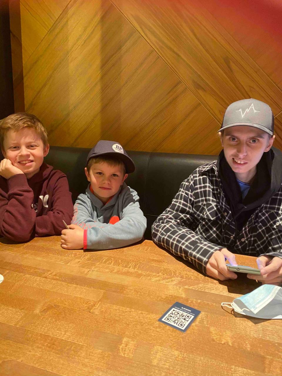 Eric Coulam and his two younger brothers while on a five-day family vacation they took in November 2020, one of the first excursions he was able to do after a months-long stay in an Alberta hospital (GoFundMe)