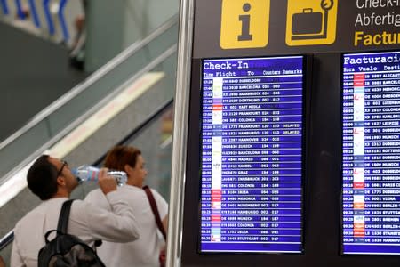 Flight information boards are seen at Mallorca Airport as an announcement is expected on the Thomas Cook's tour operator, in Palma de Mallorca