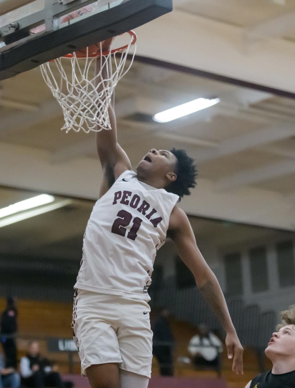 Peoria High's Leshawn Stowers dunks on East Peoria in the second half of their boys basketball game Tuesday, Nov. 28, 2023 at Peoria High School.